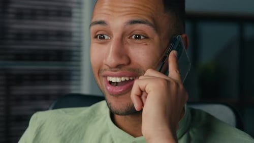 Man Reacts During Lively Smartphone Conversation Close Up