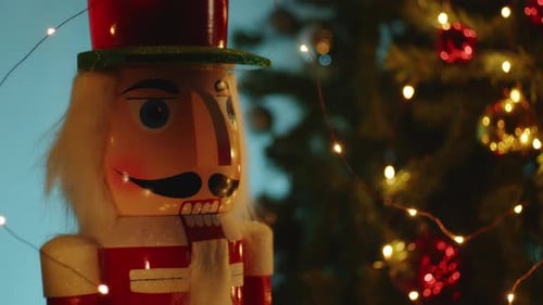 Toy Nutcracker Near the Christmas Tree