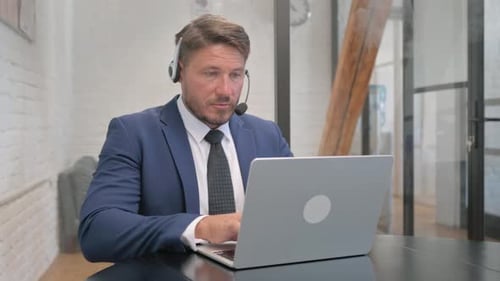 Call Center Employee Working on Laptop in Customer Service Center