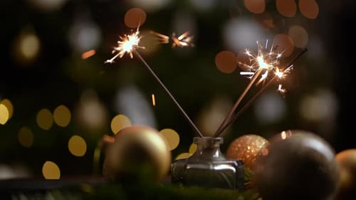 Sparklers Burning with Christmas Ornaments and Bokeh