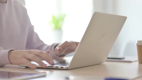 Close Up of Male Hands Typing on Laptop