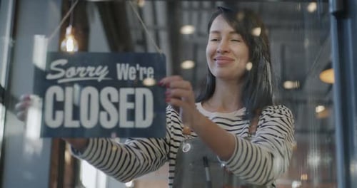 Slow Motion of Joyful Young Waitress in Apron Hanging Yes We are Open Sign on Cafe Door Waiting for
