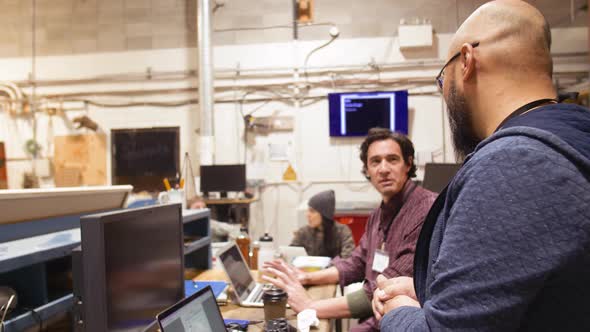 Computer Programmers Talking at Laptops During Hackathon, Industrial ...
