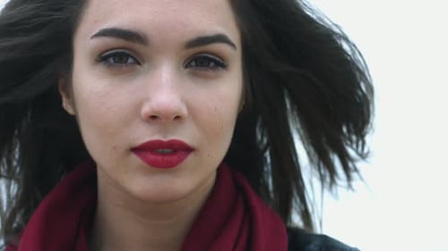 Portrait Beautiful Woman Touching Brunette Hair Moving on Wind. Close Up Attractive