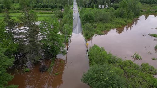 Flooded road closed due to bridge overflowing with river water post tropical storm