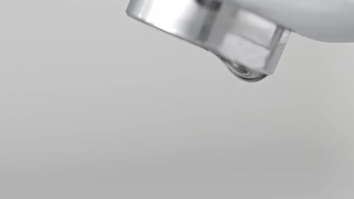 Water Dripping From Faucet Spout in Slow Motion