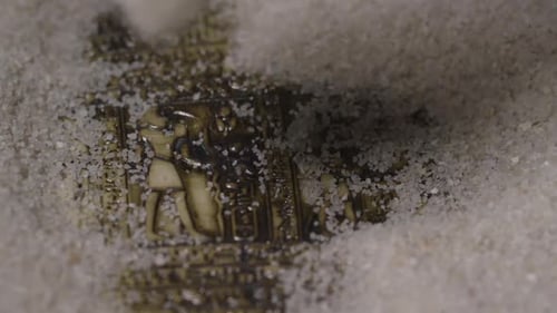 Artifact Uncovered With Brush in Sand