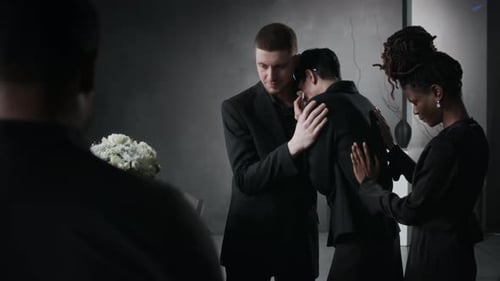 People Comforting Each Other at Funeral