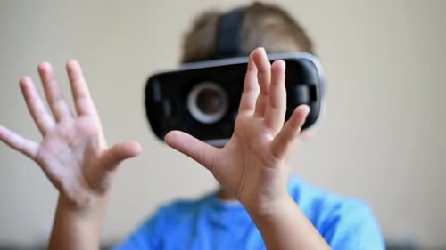 Boy Experiences Virtual Reality with VR Headset