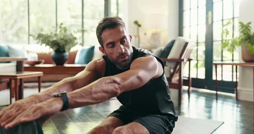 Man Stretching on Yoga Mat at Home