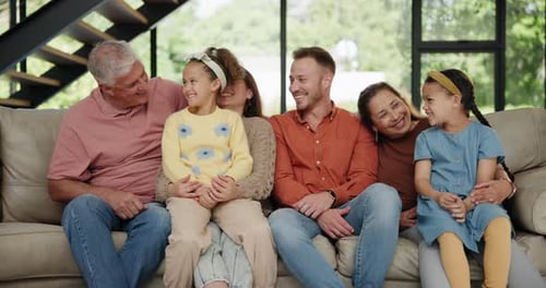 Happy Family Smiling Together on Couch at Home