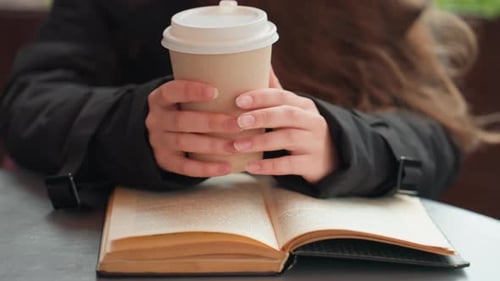Female Pauses to Savor Beverage Woman Finds Comfort in Her Warm Beverage at Cafe Young Woman Pauses
