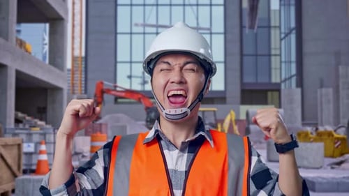 Close Up Of Asian Male Engineer Screaming Goal Celebrating Working at Construction Site