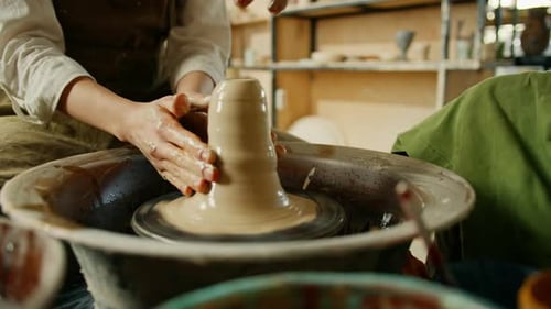 Pottery workshop a potter works with a potter's wheel a product made of clay a potter conducts