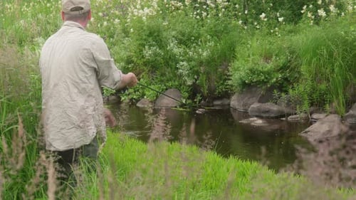 Man fly fishing in a small stream