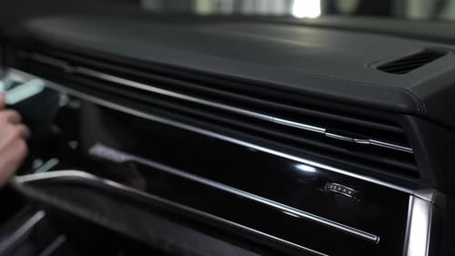 Hand Cleaning Car Interior With Cloth and Brush