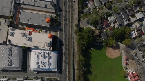 Top Down Panning Footage of Street and Railway Tracks Leading Through Urban Borough