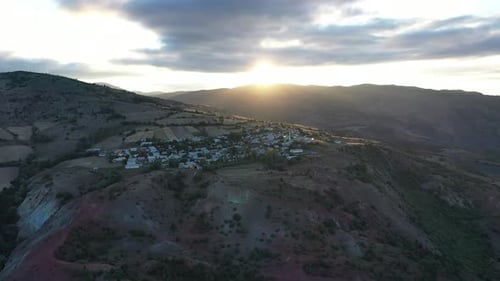 Aerial View Of Village On Mountain Slope At Sunrise