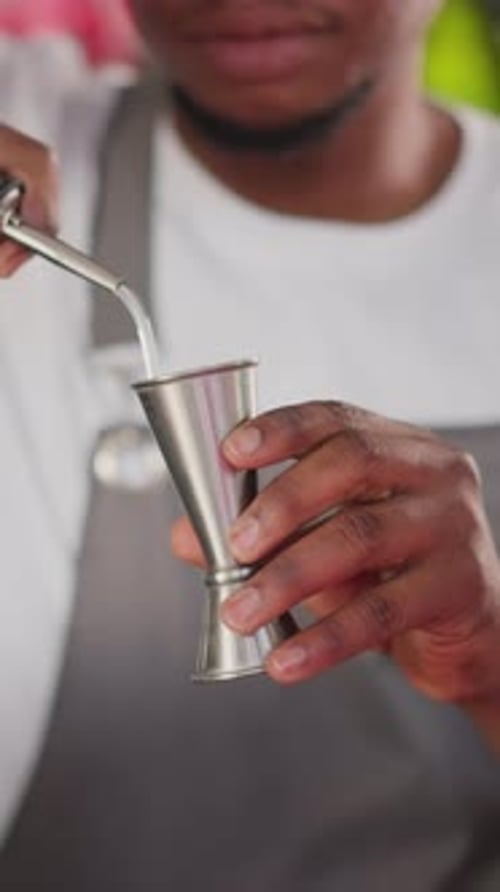 Barman Pours Liqueur Into Jigger in Club