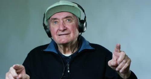 Senior Man Enjoys Music on Headphones