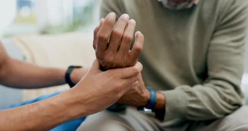 Medical Professional Examining Senior's Wrist and Hand