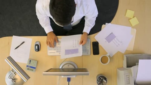 Timelapse Overhead Shot Of Businessman Working At Office Desk