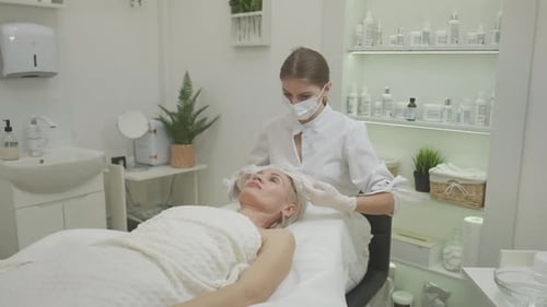 Beautician Preparing Client for Beauty Procedure