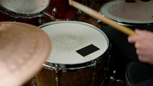 drummer plays a drum kit in a recording studio at a professional musician rehearsal recording a song