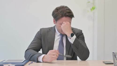 Portrait of Middle Aged Businessman having Headache in Office
