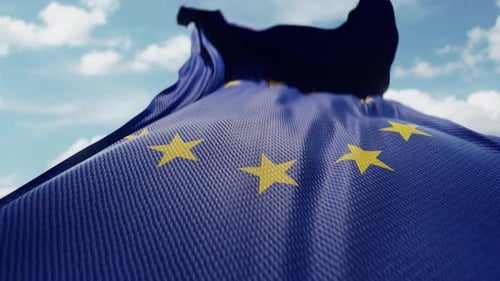 Realistic Waving European Union Flag Against Blue Sky