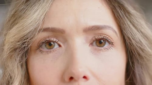 Portrait of happy eyes of caucasian casual businesswoman in office, slow motion
