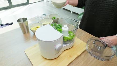 Adding Peppers and Herbs to a Food Processor