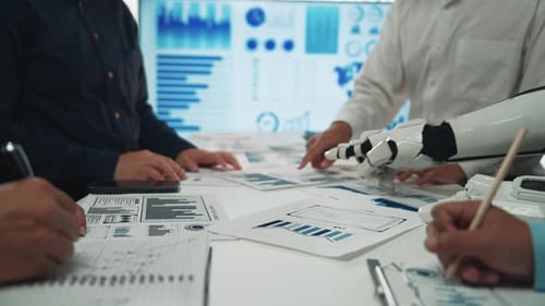 Business Team Brainstorming with Robot Hand Pointing Graphs