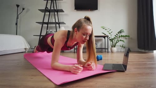 Woman Doing Plank Exercise in Living Room