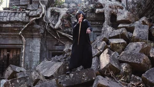 Masked Figure Wields Sword in Ancient Ruins