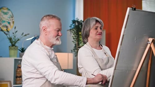 Senior Couple Painting Together in Living Room