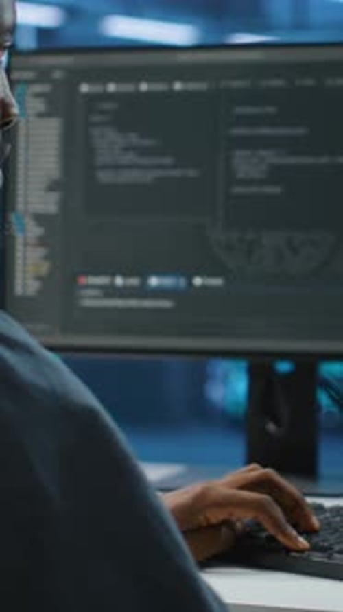 Vertical Video Technician in Data Center Doing System Analysis Typing Data on PC