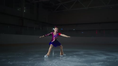 Future Champion Of Figure Skating Little Girl Training On Ice In Dark Ice Rink In Sport Arena