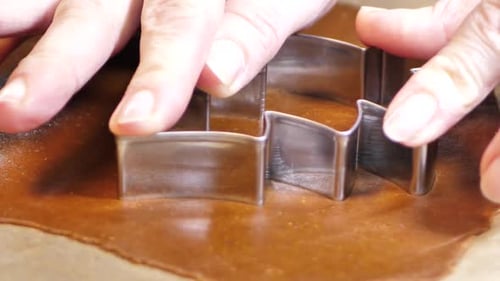Cutting Christmas Tree Cookie from Dough with Cutter