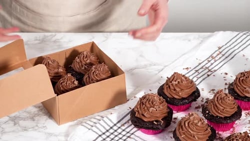 Packaging Chocolate Cupcakes with Chocolate Ganache Frosting Into a Paper Cupcake Box