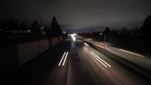 Moving hyperlapse at night of cars on freeway. Timelapse light streaks