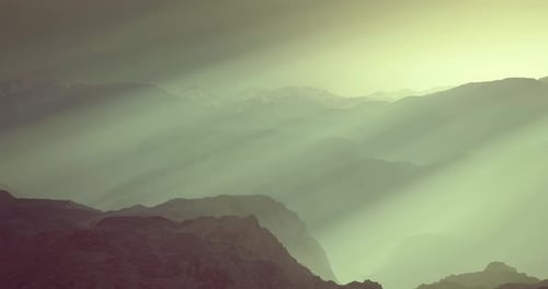 Majestic Mountain Landscape with Gentle Light Rays in Morning Mist