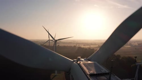 Aerial View of Wind Turbines Standing in a Field at Sunrise