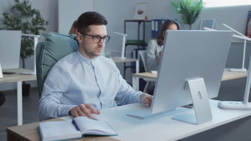 Man working at computer in bright office