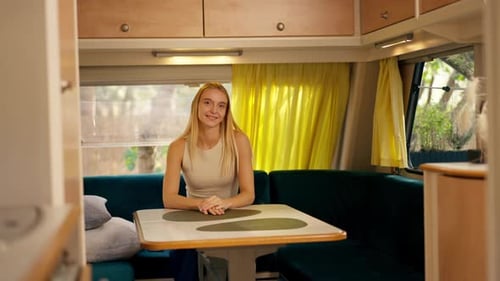 Young Woman Smiling in a Camper Interior
