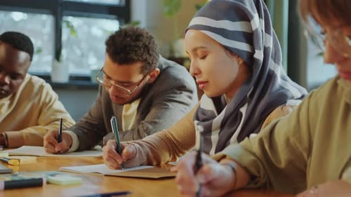 Diverse Young Adults Collaborate in Bright Workplace