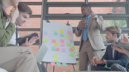 Lower view of African American business man stand to present team project with co-worker