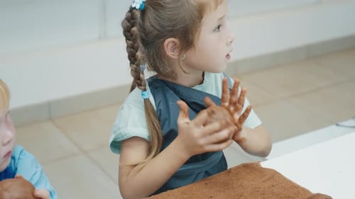 Kids Learn Pottery and Shape the Clay in the Pottery Workshop During Masterclass