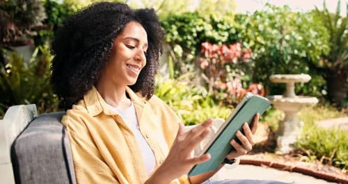Woman, smile and scroll with tablet in backyard for reading blog, social media post