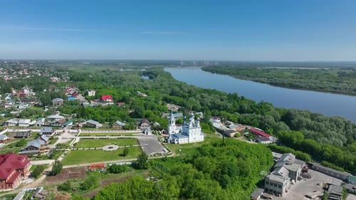 Aerial view of a historic church in a town near a river